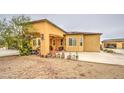Charming home with stucco exterior, front porch, mature landscaping and an attached garage at 8210 S 132Nd Ave, Goodyear, AZ 85338