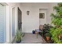 Inviting porch area with comfortable seating, potted plants, and a secured front door at 10 W Georgia Ave # 8, Phoenix, AZ 85013