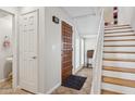 Welcoming foyer with tile floors, a staircase, and a striking wooden front door at 10 W Georgia Ave # 8, Phoenix, AZ 85013