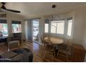 Bright dining area featuring wood floors, a bay window, and a stylish modern light fixture at 1118 S Shawnee Dr, Apache Junction, AZ 85119