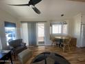 Cozy living room features wood flooring, ample natural light, and a ceiling fan at 1118 S Shawnee Dr, Apache Junction, AZ 85119