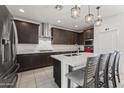 Gourmet kitchen featuring dark wood cabinets, sleek countertops, and a spacious center island at 11607 W Marguerite Ave, Avondale, AZ 85323