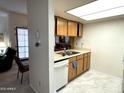 Functional kitchen featuring ample counter space, classic wooden cabinets, white appliances and tile floor at 145 N 74Th St # 236, Mesa, AZ 85207