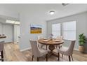 Dining room with a round wood table, neutral-toned chairs, and a bright window at 1518 E Mineral Rd, Gilbert, AZ 85234