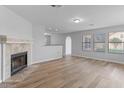 Inviting living room with a fireplace, laminate floors, and large windows offering plenty of natural light at 1518 E Mineral Rd, Gilbert, AZ 85234