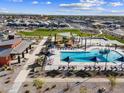 Aerial view of community pool, playground, and green space with well-kept landscaping at 162 S 177Th Ln, Goodyear, AZ 85338
