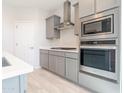 Close-up of the modern kitchen appliances including the stainless steel oven, microwave and cooktop at 19801 W Badgett Ln, Litchfield Park, AZ 85340