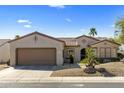 Charming single-story home featuring desert landscaping, a tile roof, and an attached two-car garage at 20139 N Rawhide Way, Surprise, AZ 85387