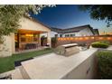 Inviting outdoor kitchen and covered patio with string lights, perfect for evening entertaining at 20906 E Macaw Dr, Queen Creek, AZ 85142