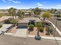 Stunning aerial view showcasing a home with desert landscaping and a tile roof in a well-planned community at 21141 E Stirrup St, Queen Creek, AZ 85142