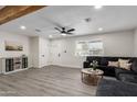 Bright living room featuring a large sectional sofa, hardwood floors, and a view of the entertainment center at 2161 E Corona Ave, Phoenix, AZ 85040