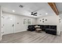 Spacious living room with a large sofa, ceiling fan, and decorative wooden beam at 2161 E Corona Ave, Phoenix, AZ 85040