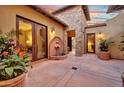 Idyllic courtyard featuring a stone fountain, potted plants, and elegant architecture for a serene outdoor living space at 28689 N 67Th Dr, Peoria, AZ 85383