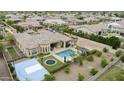 Lush backyard retreat features a sparkling pool, sports court, shaded cabana, and mature landscaping for ultimate relaxation and enjoyment at 3314 E Kael St, Mesa, AZ 85213
