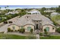 Aerial view of a charming home with desert landscaping, a tile roof, and lush greenery at 3314 E Kael St, Mesa, AZ 85213