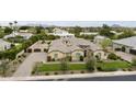 An attractive home with a desert landscape, tile roof, and lush greenery from a street view at 3314 E Kael St, Mesa, AZ 85213