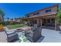 Inviting backyard with a covered patio, fire pit, and lush green lawn at 3397 E Derringer Way, Gilbert, AZ 85297