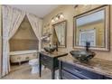 Elegant bathroom with dual sinks, marble countertops, and a clawfoot tub at 3397 E Derringer Way, Gilbert, AZ 85297