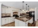 Spacious kitchen featuring white cabinetry, granite countertops, tile backsplash, and stainless steel appliances at 3397 E Derringer Way, Gilbert, AZ 85297