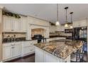 Spacious kitchen featuring granite counters, black appliances, and ample cabinet space at 3397 E Derringer Way, Gilbert, AZ 85297
