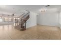 Bright living area showcasing tile floors and staircase with decorative wrought iron railing at 3397 E Derringer Way, Gilbert, AZ 85297