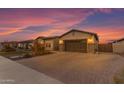 Spacious, brick paver driveway leading to a two-car garage surrounded by desert landscaping and a charming home at 3502 E Hazeltine Way, Queen Creek, AZ 85142