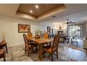 Inviting living space with fireplace, dining area, hardwood floors and natural light at 36601 N Mule Train Rd # B14, Carefree, AZ 85377