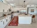 Modern kitchen featuring stainless steel appliances, white cabinets, and a granite-topped island at 3811 N 64Th St, Scottsdale, AZ 85251