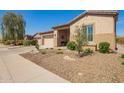 Single-story home with desert landscaping, a covered porch with a bench, and a two-car garage at 4086 E Narrowleaf Dr, Gilbert, AZ 85298