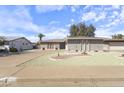 Charming single-story home featuring a well-manicured yard with desert landscaping and mature trees at 5142 E Edgewood Cir, Mesa, AZ 85206
