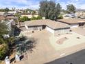 Well-maintained single-story home with an attached garage and circular driveway, offering desert landscaping and curb appeal at 5142 E Edgewood Cir, Mesa, AZ 85206
