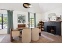 Elegant dining room features a black brick fireplace, stylish decor, and herringbone wood floors at 521 W Cambridge Ave, Phoenix, AZ 85003