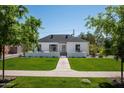 Charming home with a well-manicured lawn, neatly trimmed trees, and a welcoming walkway at 521 W Cambridge Ave, Phoenix, AZ 85003