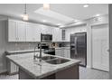 Modern kitchen featuring white cabinets, stainless steel appliances, granite countertops, and ample natural light at 5342 S Farmer Ave, Tempe, AZ 85283