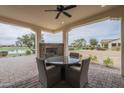 Outdoor covered patio area features a fireplace and a round table with seating, perfect for outdoor entertaining at 583 E Peach Tree St, Queen Creek, AZ 85140