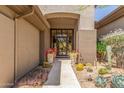 A decorative front door welcomes you to a beautifully landscaped entrance with desert plants at 9440 N Sunset Rdg, Fountain Hills, AZ 85268