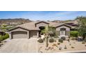 Stunning single-story home featuring a desert landscape, spacious 3-car garage and neutral color palette at 9440 N Sunset Rdg, Fountain Hills, AZ 85268