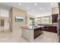 Open kitchen with a granite island, stainless steel appliances, and access to outdoor patio at 9440 N Sunset Rdg, Fountain Hills, AZ 85268