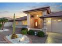 Inviting front entrance with decorative rock landscaping and private courtyard at 10843 E Kilarea Ave, Mesa, AZ 85209