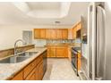 Bright kitchen featuring stainless steel appliances and granite countertops at 10843 E Kilarea Ave, Mesa, AZ 85209
