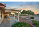 Covered patio with view of beautifully landscaped backyard and golf course at 10843 E Kilarea Ave, Mesa, AZ 85209