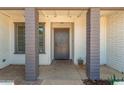 Inviting front porch with support pillars and a gray front door creating a welcoming entrance at 1311 W Palo Verde Dr, Chandler, AZ 85224
