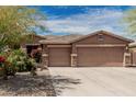 Charming home featuring a three-car garage, tile roof, and desert landscaping at 13146 S 178Th Ave, Goodyear, AZ 85338