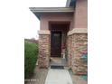 Charming front entryway with stone pillars, desert landscaping, and a decorative security door at 13146 S 178Th Ave, Goodyear, AZ 85338