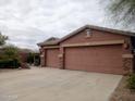 Spacious three-car garage on a single-story home with a large driveway for ample parking at 13146 S 178Th Ave, Goodyear, AZ 85338