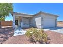 Well-maintained home featuring desert landscaping, a welcoming front porch, and a two-car garage at 1825 E Sycamore Rd, Casa Grande, AZ 85122