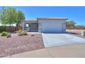 Charming home with desert landscaping, inviting front porch, and a convenient two-car garage, and modern driveway at 1825 E Sycamore Rd, Casa Grande, AZ 85122