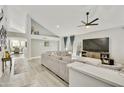 Bright living room featuring vaulted ceilings, modern furnishings, and neutral tones, perfect for relaxation at 18665 N 70Th Dr, Glendale, AZ 85308