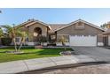 Inviting single-story home featuring a tile roof, desert landscaping, and a two-car garage at 21 W Pecan Pl, Tempe, AZ 85284