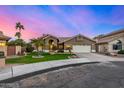 Inviting single-story home featuring a tile roof, desert landscaping, and a two-car garage at 21 W Pecan Pl, Tempe, AZ 85284
